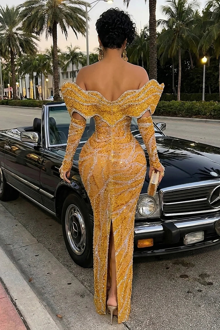 Yembi Fashion gold crystal maxi dress with structured off the shoulder ruffled collar, long sleeves, sheer nude illusion mesh, and wavy silver rhinestone lines