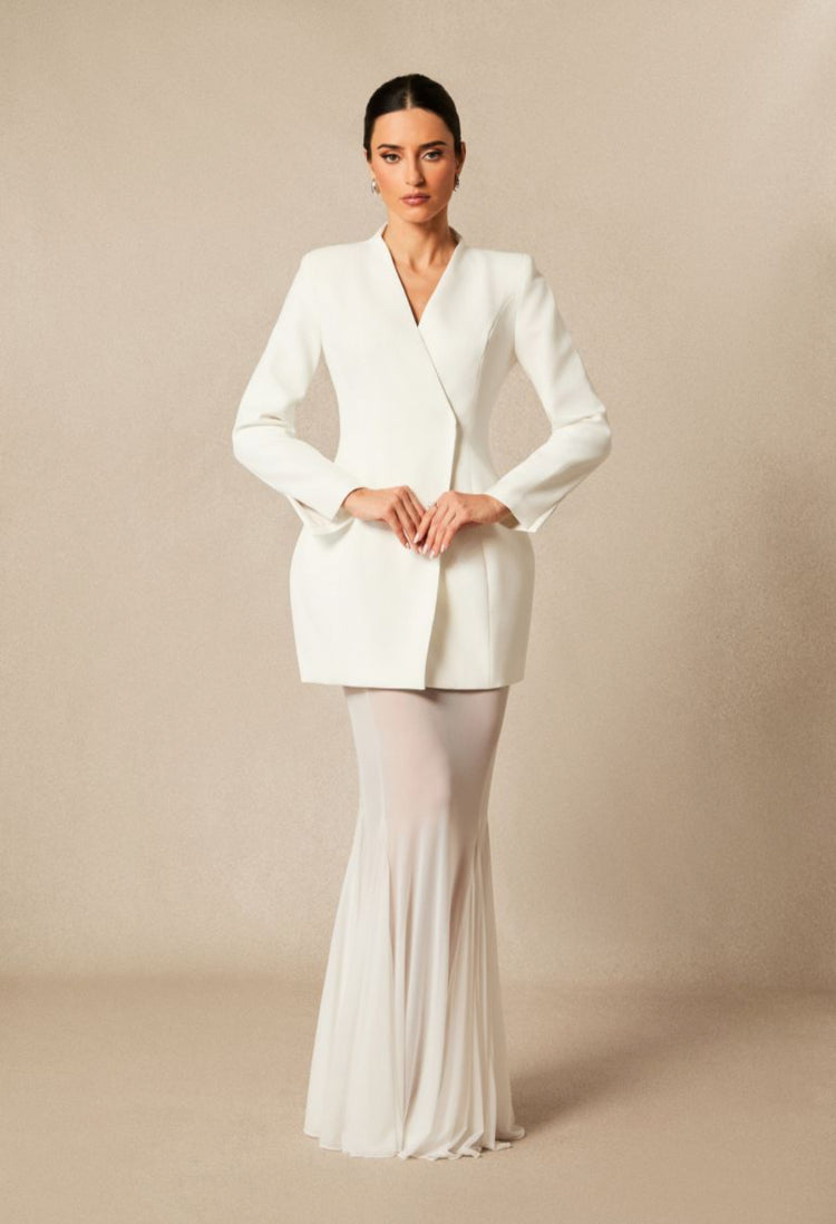 Yembi Fashion luxury white blazer mermaid gown featuring a structured tuxedo jacket bodice and a dramatic sheer pleated mermaid train skirt
