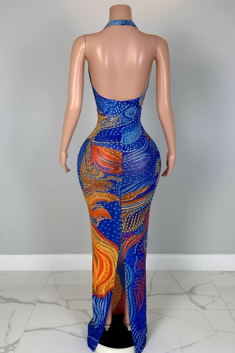 Yembi Fashion multicolor crystal maxi dress with halter neckline, sheer nude illusion mesh, and abstract swirling patterns of royal blue and orange rhinestones
