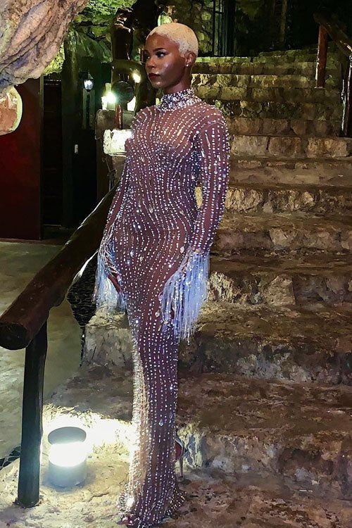 Yembi Fashion nude illusion crystal gown with sheer brown mesh, vertical wavy silver rhinestone patterns, and hanging crystal fringe cuffs