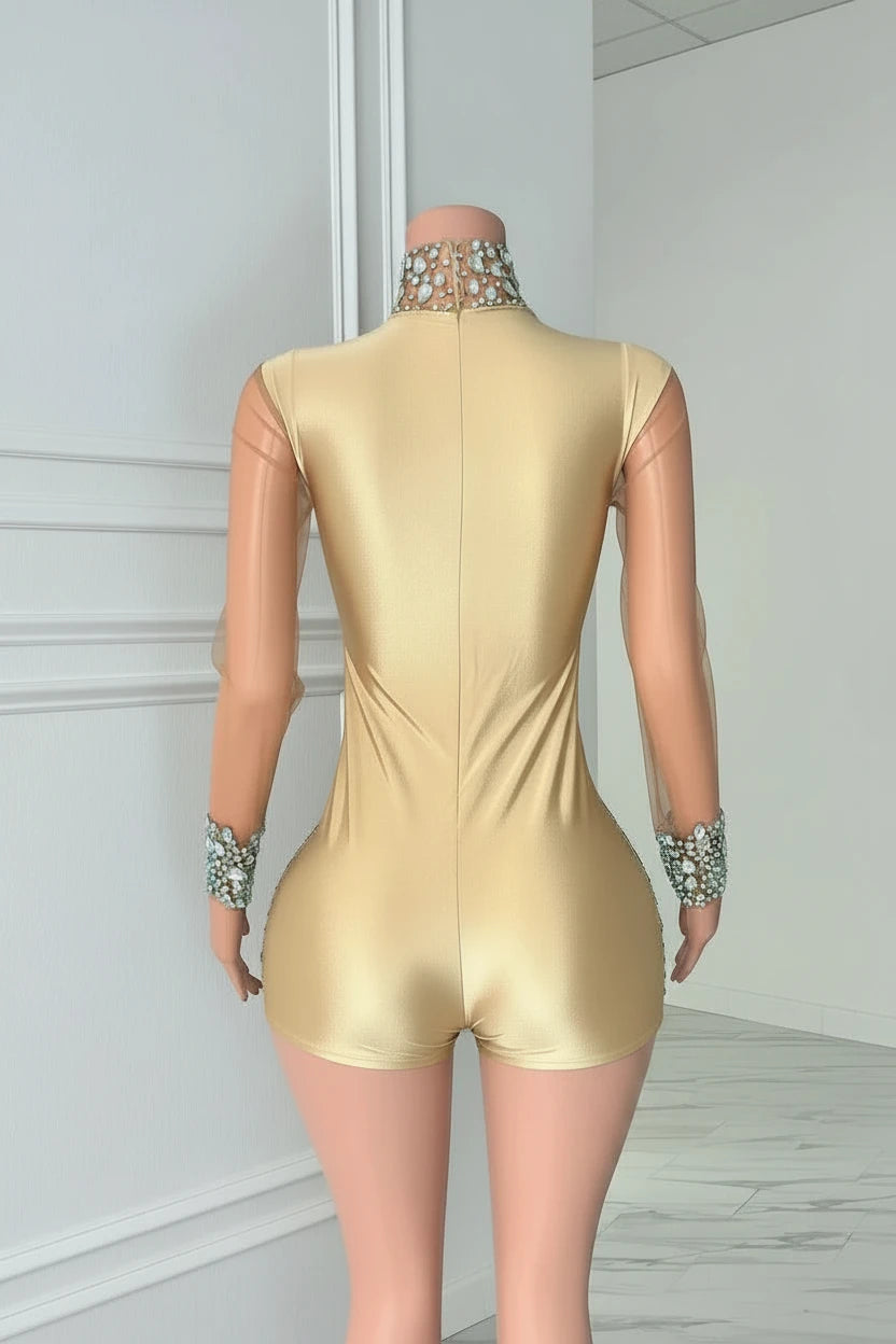 Yembi Fashion luxury silver rhinestone romper featuring a high-density crystal bustier and high-waisted sparkly shorts layout on a nude illusion sheer mesh long sleeve bodysuit