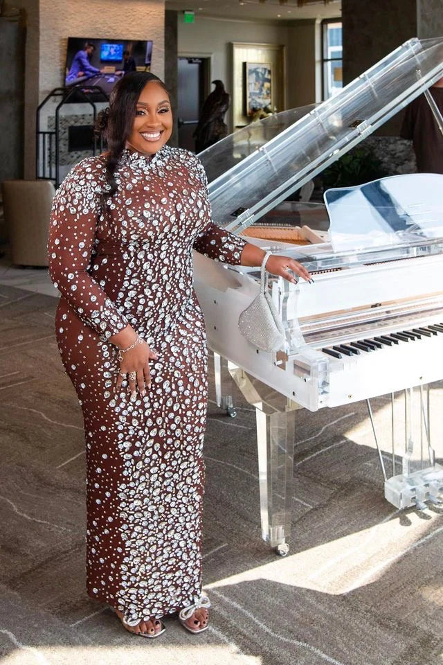 Yembi Fashion heavy crystal embellished nude illusion gown with high mock neck and dense constellation of oversized silver rhinestones on caramel mesh