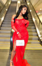 Yembi Fashion red lace maxi dress with strapless corset bodice, tone-on-tone ruby crystal embellishments, dramatic side draping, and matching opera lace gloves