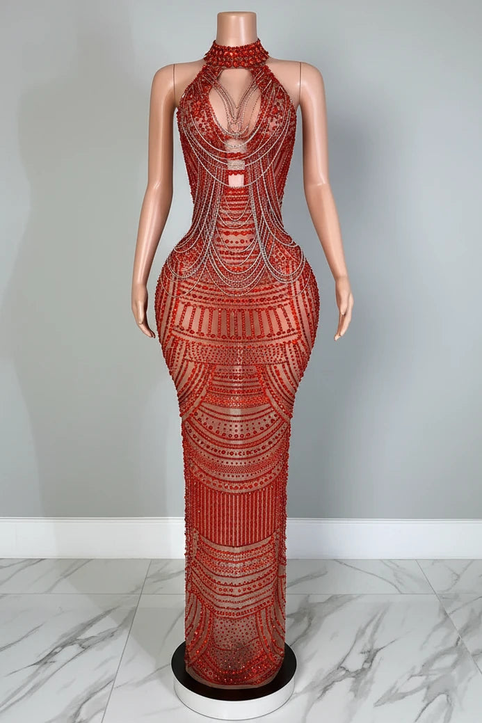 Mannequin wearing a red beaded evening gown in an elegant room setting.
