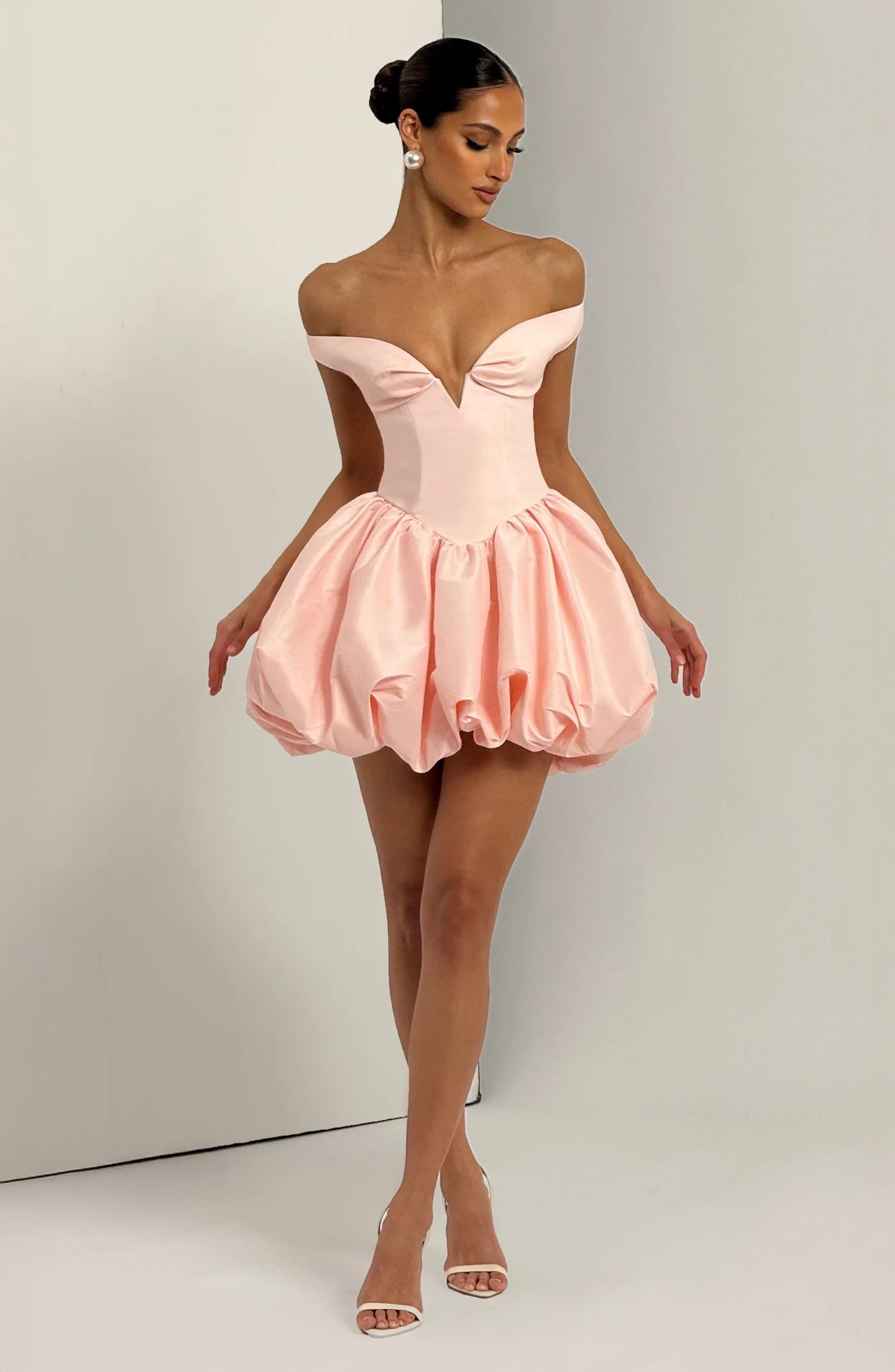 Yembi Fashion luxury pink off-the-shoulder puff mini dress featuring a structured corset bodice with a plunging V-neckline and dramatic bubble skirt