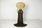 Yembi Fashion gold crystal maxi dress with structured avant-garde fan collar, sheer black nude illusion mesh, and vertical rhinestone linear lines with high slit
