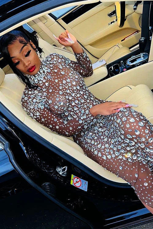 Yembi Fashion heavy crystal embellished nude illusion gown with high mock neck and dense constellation of oversized silver rhinestones on caramel mesh