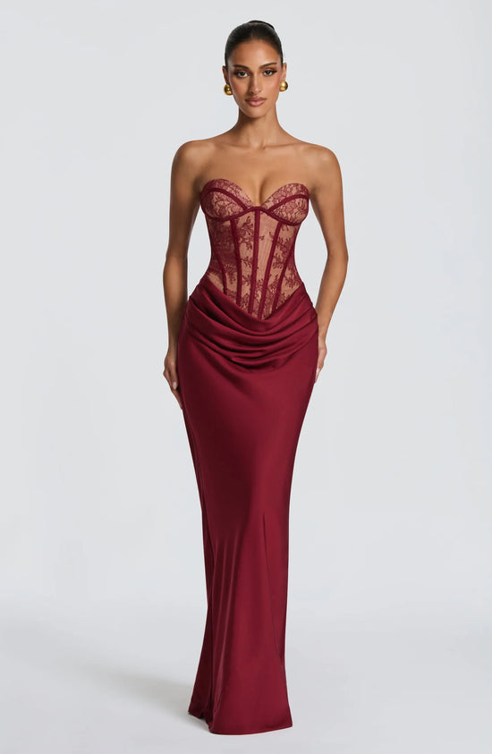 Yembi Fashion luxury red strapless maxi gown featuring a structured corset bodice and a dramatic draped basque waist skirt