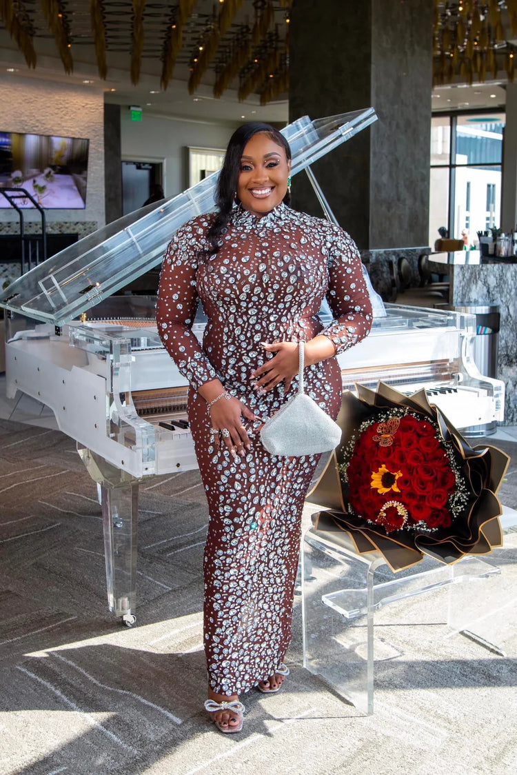 Yembi Fashion heavy crystal embellished nude illusion gown with high mock neck and dense constellation of oversized silver rhinestones on caramel mesh