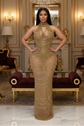 Yembi Fashion gold crystal maxi dress with high neck choker collar, plunging cutout bodice, draped chest chains, and sheer nude illusion mesh