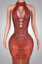 Red beaded dress on a mannequin against a decorative wall.