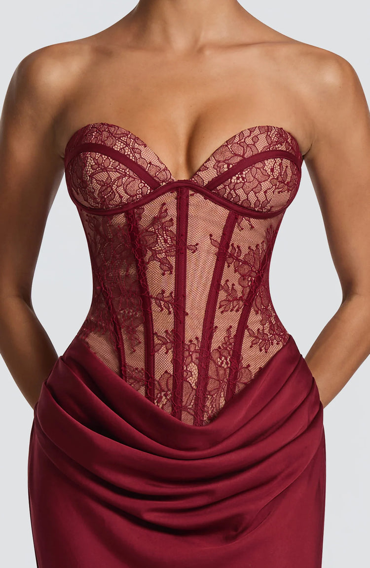 Yembi Fashion luxury red strapless maxi gown featuring a structured corset bodice and a dramatic draped basque waist skirt