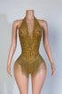 Yembi Fashion luxury gold rhinestone fringe bodysuit featuring a sparkly crystal halter bodice with a plunging deep V-neckline and cascading metallic fringe chains