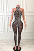 Yembi Fashion luxury black spider web rhinestone jumpsuit featuring a high-density crystal spiderweb pattern on a nude illusion sheer mesh halter neck catsuit