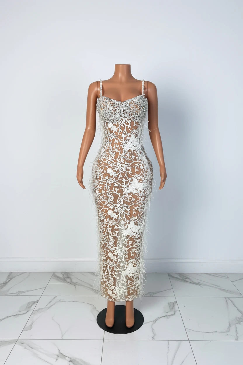 Yembi Fashion feather crystal maxi dress with thin pearl straps, sheer nude illusion mesh, white floral rhinestone embroidery, and side ostrich feathers