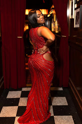Yembi Fashion red rhinestone maxi dress with dramatic chest and hip cutouts, high neck, and vertical crystal line detailing