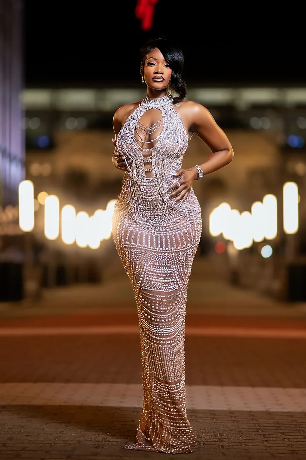 Yembi Fashion silver rhinestone maxi dress with high neck choker collar, plunging cutout bodice, draped chest chains, and sheer nude illusion mesh