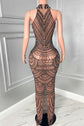 Yembi Fashion black rhinestone maxi dress with nude illusion mesh, embellished halter neck, and layered metallic body chains
