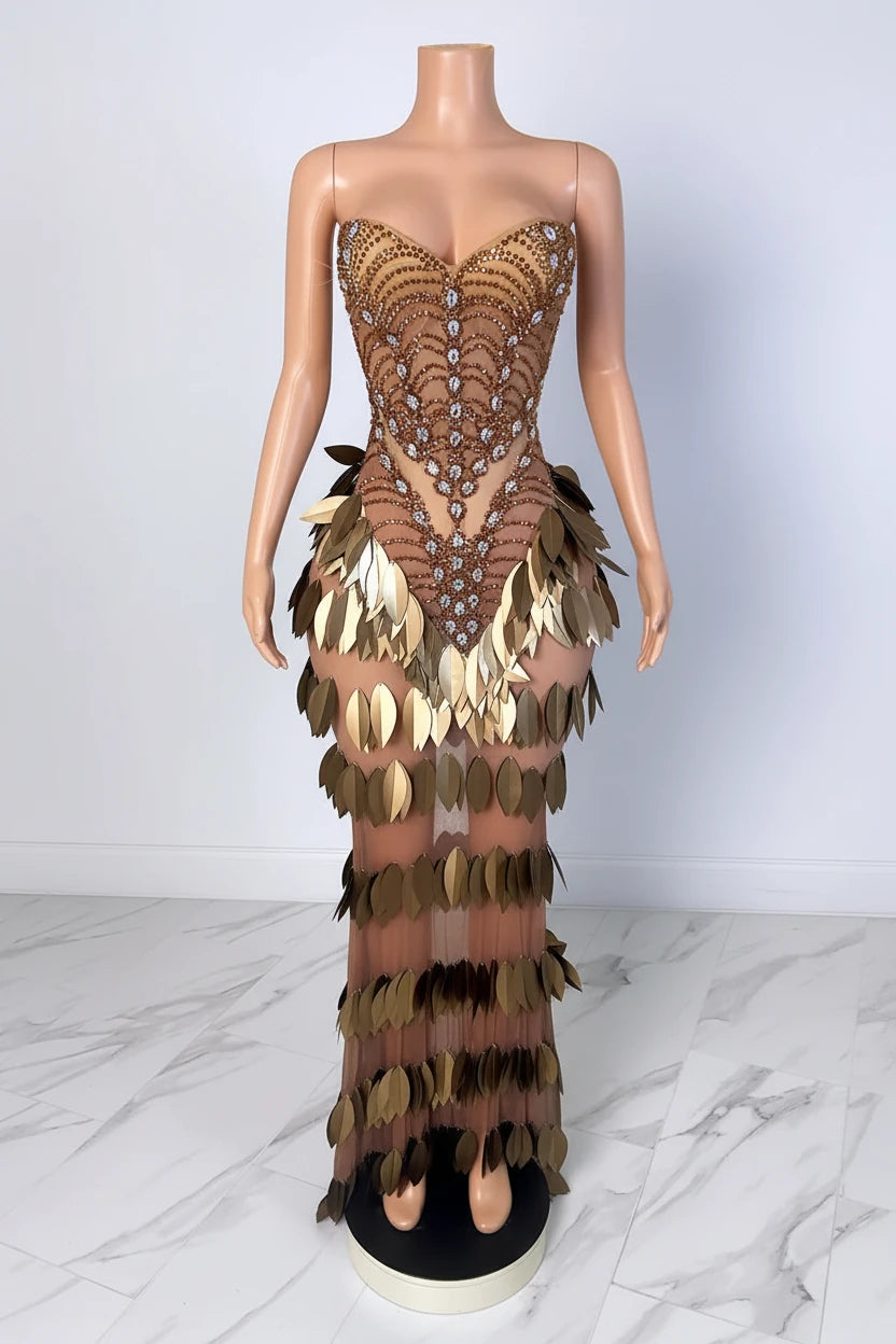 Yembi Fashion gold crystal maxi dress with strapless sweetheart neckline, sheer nude illusion mesh, amber rhinestone bodice, and tiered rows of metallic gold leaf scales
