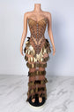 Yembi Fashion gold crystal maxi dress with strapless sweetheart neckline, sheer nude illusion mesh, amber rhinestone bodice, and tiered rows of metallic gold leaf scales