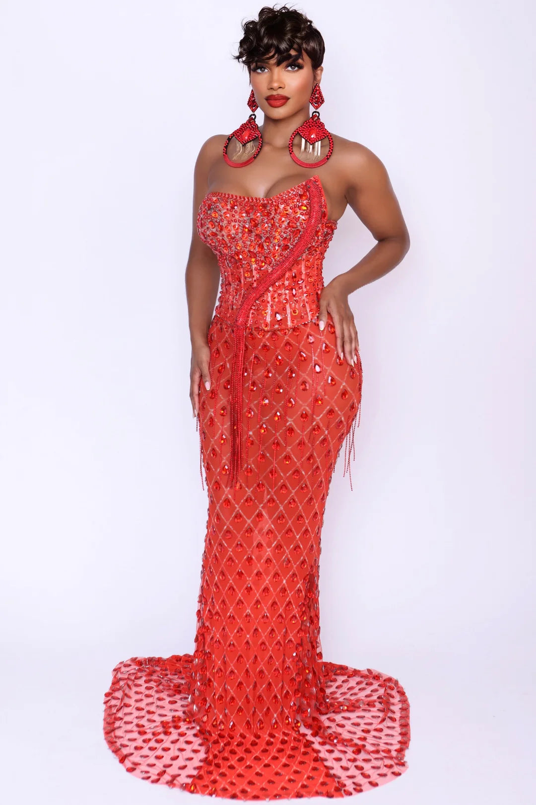 Yembi Fashion red rhinestone mermaid gown with strapless corset bodice, sheer nude-illusion mesh, and heavy geometric crystal lattice beading