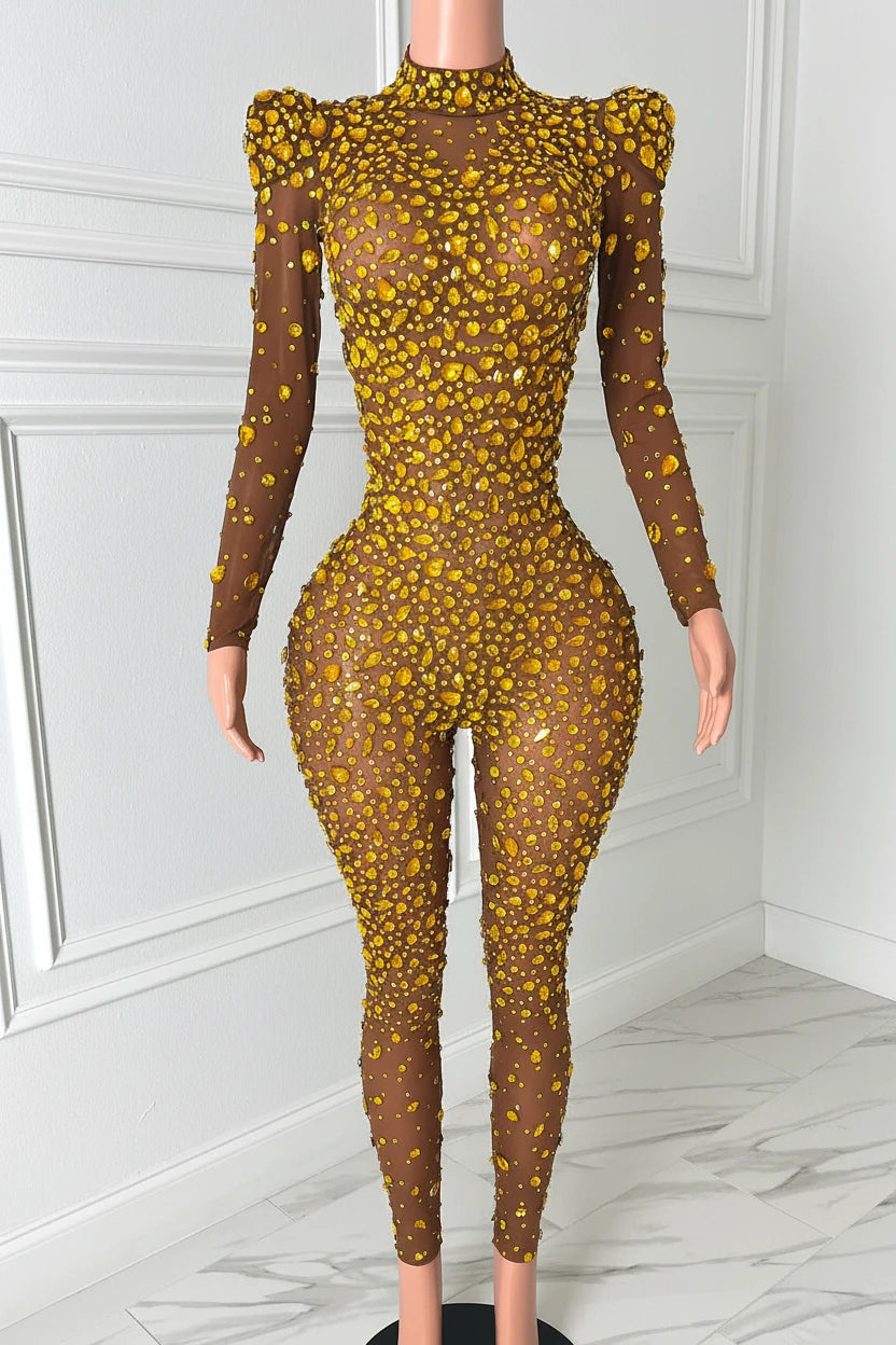Yembi Fashion gold rhinestone jumpsuit with nude illusion mesh, high mock neck, and structured puff shoulders adorned with yellow crystals