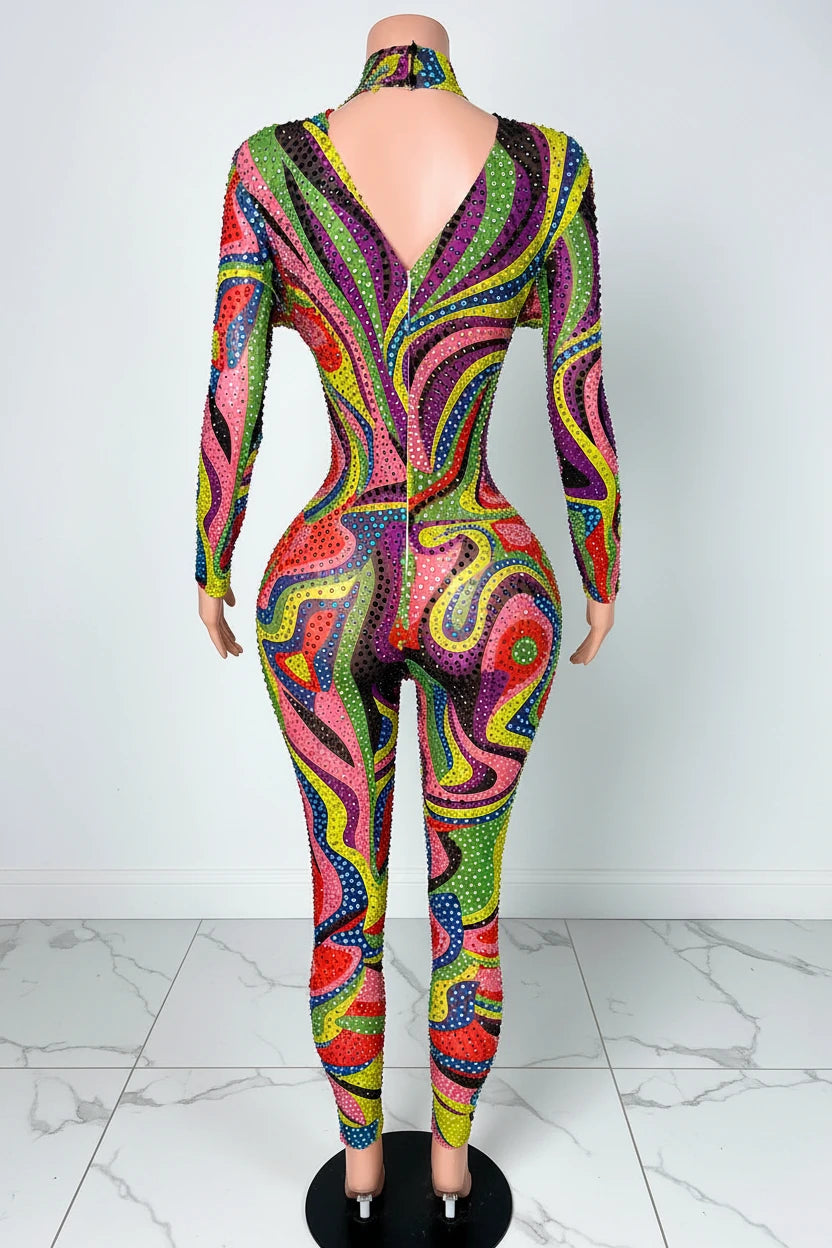Yembi Fashion luxury multicolor rhinestone jumpsuit featuring a psychedelic abstract wavy swirl pattern of vibrant rainbow crystals on a nude illusion mock neck catsuit