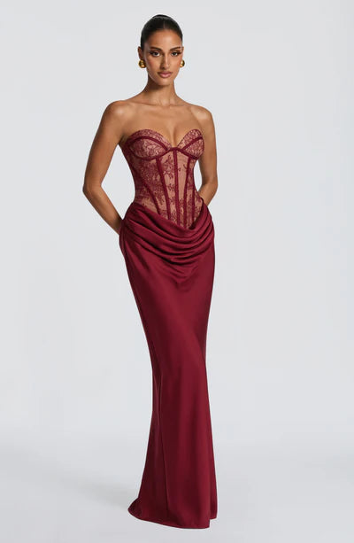 Yembi Fashion luxury red strapless maxi gown featuring a structured corset bodice and a dramatic draped basque waist skirt