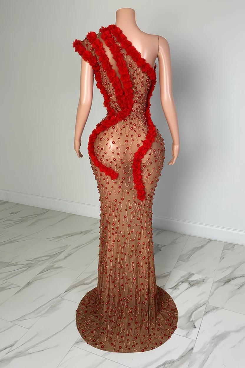 Yembi Fashion red rhinestone maxi dress with asymmetric one shoulder neckline, sheer nude illusion mesh, ruby crystals, and bold red ruffled fabric trim