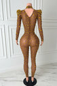 Yembi Fashion gold rhinestone jumpsuit with nude illusion mesh, high mock neck, and structured puff shoulders adorned with yellow crystals