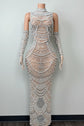 Yembi Fashion silver rhinestone maxi dress with high mock neck, sheer beige nude illusion mesh, geometric scalloped patterns of crystals and white pearls, and matching embellished gloves