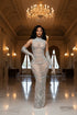 Yembi Fashion silver rhinestone maxi dress with high mock neck, sheer beige nude illusion mesh, geometric scalloped patterns of crystals and white pearls, and matching embellished gloves