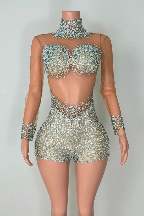 Yembi Fashion luxury silver rhinestone romper featuring a high-density crystal bustier and high-waisted sparkly shorts layout on a nude illusion sheer mesh long sleeve bodysuit