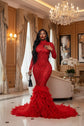 Yembi Fashion red feather crystal gown with high mock neck, long sleeves, nude illusion mesh bodice with ruby rhinestone beadwork, and plush ostrich feather mermaid train