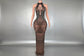 Yembi Fashion black rhinestone maxi dress with nude illusion mesh, embellished halter neck, and layered metallic body chains