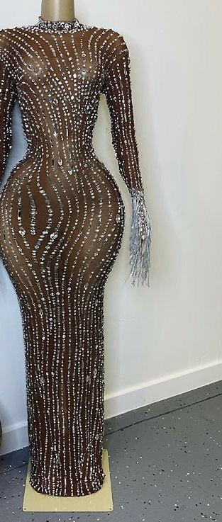 Yembi Fashion nude illusion crystal gown with sheer brown mesh, vertical wavy silver rhinestone patterns, and hanging crystal fringe cuffs