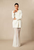 Yembi Fashion luxury white blazer mermaid gown featuring a structured tuxedo jacket bodice and a dramatic sheer pleated mermaid train skirt