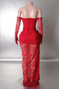 A glamorous red lace long dress with intricate dYembi Fashion red lace maxi dress with strapless corset bodice, tone-on-tone ruby crystal embellishments, dramatic side draping, and matching opera lace glovesetails, designed as a versatile set dress for formal occasions.