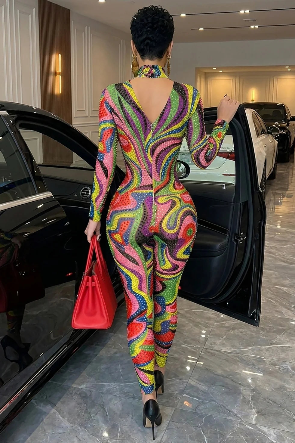 Yembi Fashion luxury multicolor rhinestone jumpsuit featuring a psychedelic abstract wavy swirl pattern of vibrant rainbow crystals on a nude illusion mock neck catsuit