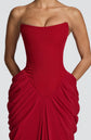 Yembi Fashion luxury red strapless maxi gown featuring a structured corset bodice and a dramatic draped basque waist skirt