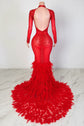 Yembi Fashion red feather crystal gown with high mock neck, long sleeves, nude illusion mesh bodice with ruby rhinestone beadwork, and plush ostrich feather mermaid train