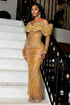 Yembi Fashion gold crystal maxi dress with structured off the shoulder ruffled collar, long sleeves, sheer nude illusion mesh, and wavy silver rhinestone lines