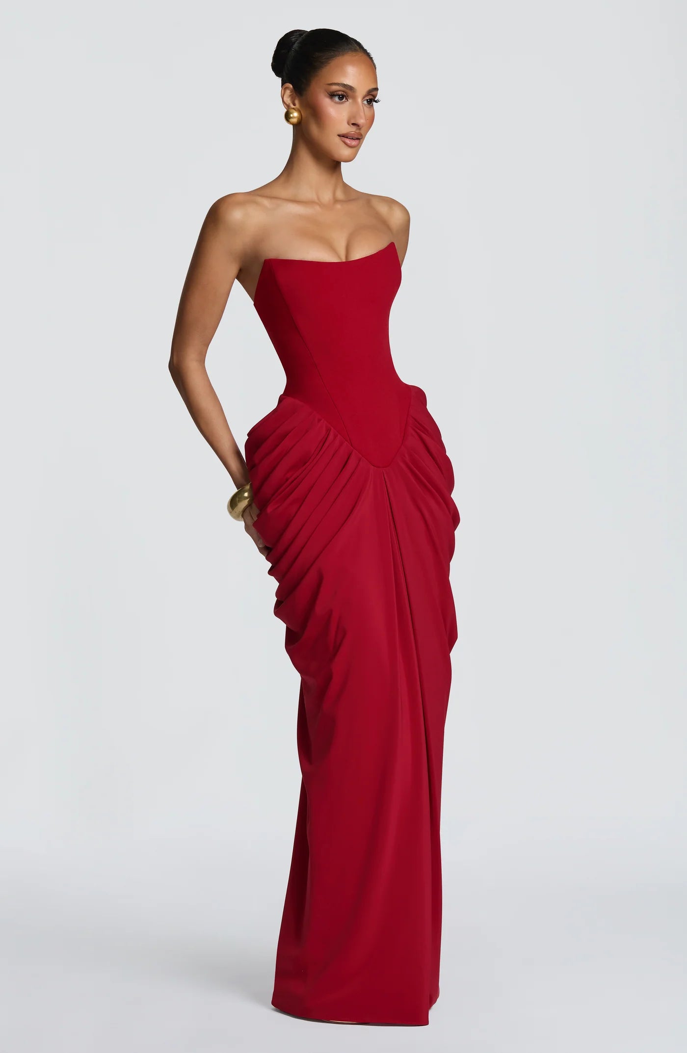 Yembi Fashion luxury red strapless maxi gown featuring a structured corset bodice and a dramatic draped basque waist skirt