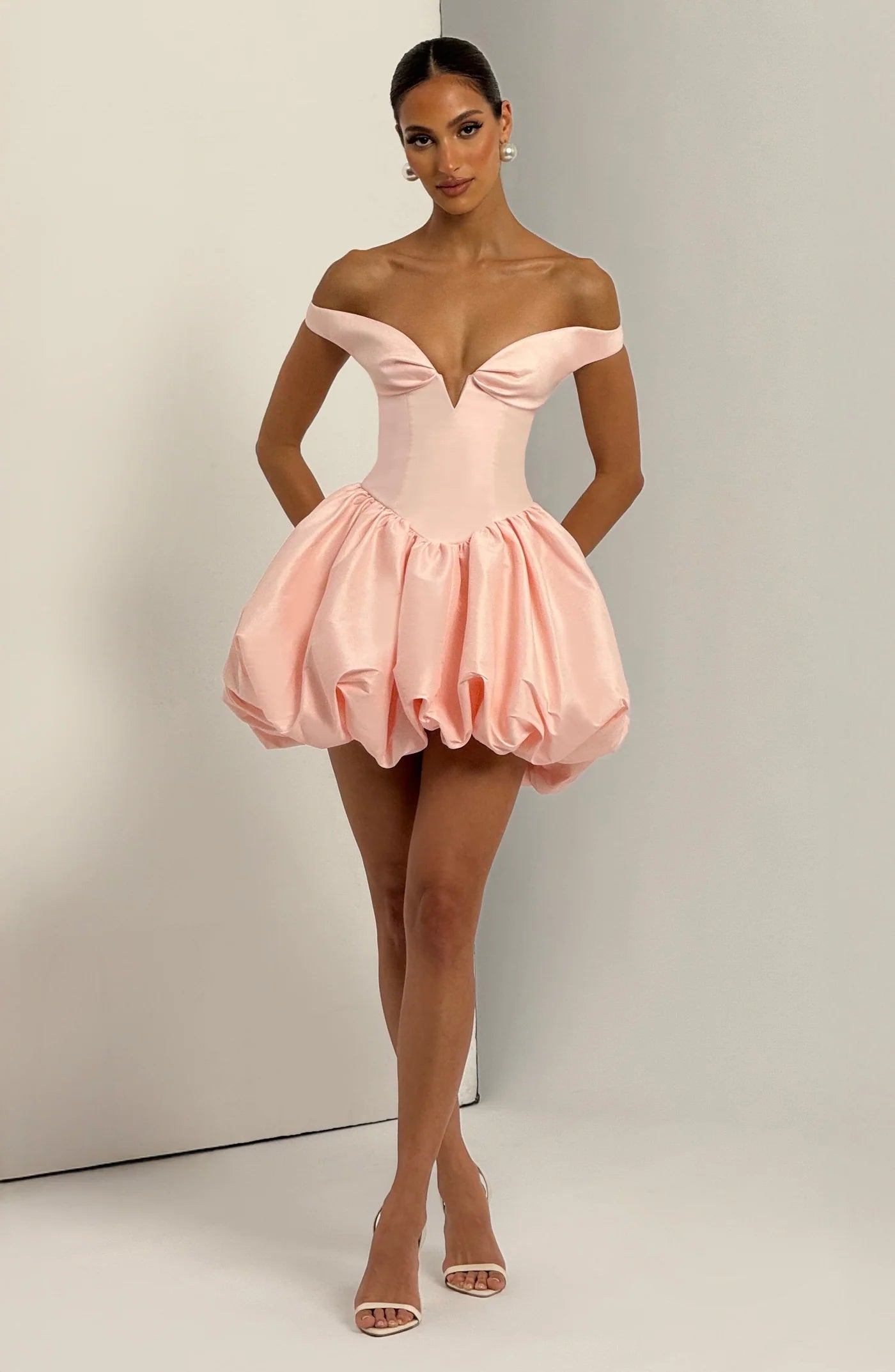 Yembi Fashion luxury pink off-the-shoulder puff mini dress featuring a structured corset bodice with a plunging V-neckline and dramatic bubble skirt