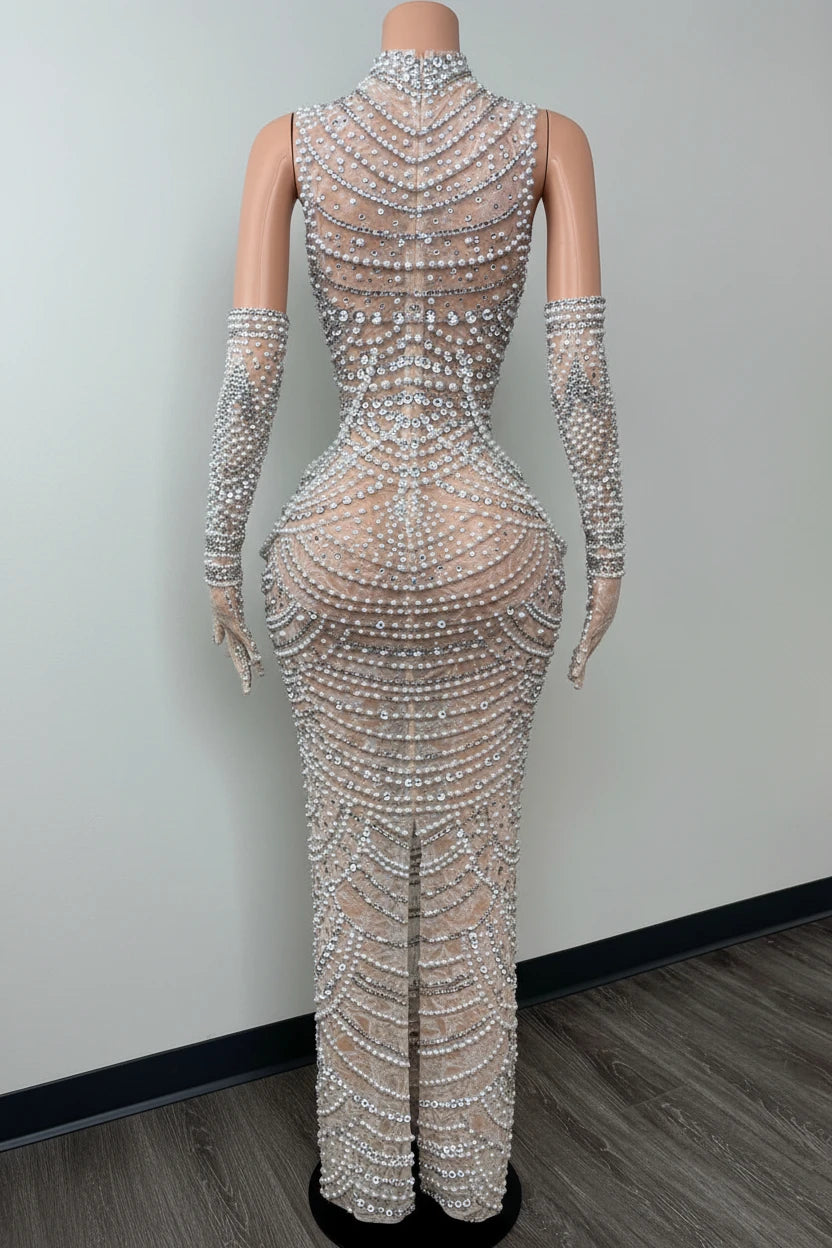 Yembi Fashion silver rhinestone maxi dress with high mock neck, sheer beige nude illusion mesh, geometric scalloped patterns of crystals and white pearls, and matching embellished gloves