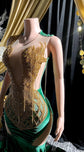 Yembi Fashion green velvet mermaid gown with gold crystal embellished bodice, shoulder fringe tassels, sheer nude illusion hip cutouts, and emerald velour train