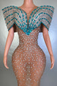 Yembi Fashion crystal embellished mermaid gown with nude illusion rhinestone mesh and structured turquoise off the shoulder wing collar