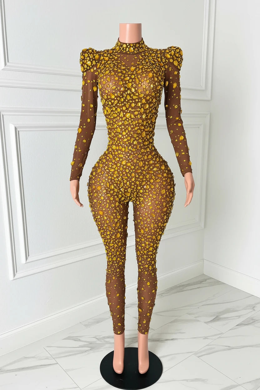 Yembi Fashion gold rhinestone jumpsuit with nude illusion mesh, high mock neck, and structured puff shoulders adorned with yellow crystals
