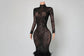 Black lace evening gown with Yembi Fashion emerald green sequin prom dress with strapless sweetheart neckline, sheer mesh thigh panel, and formal mermaid train
 skirt on a mannequin against a white wall.