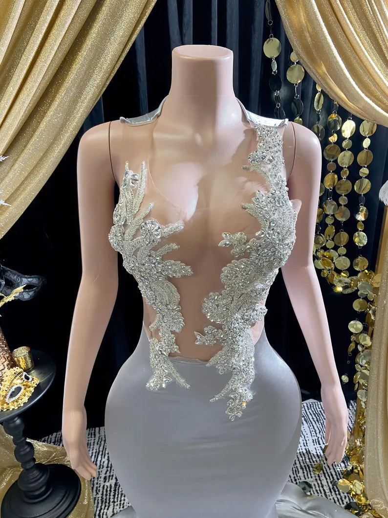 Yembi Fashion silver rhinestone mermaid gown with sheer nude illusion mesh bodice, silver crystal baroque embroidery, and fluid liquid satin train skirt